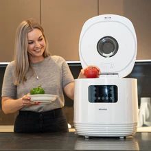 Woman in kitchen with fresh produce and TrueWashPRO